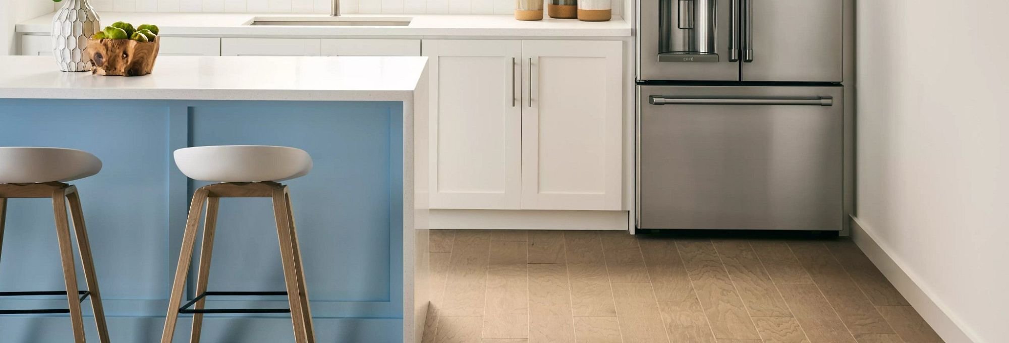 A kitchen with a fridge, table and chairs from Color World Paint and Wallcovering Center in Pittston