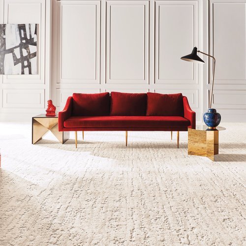 A red couch on a white capet in the middle of the room from Color World Paint and Wallcovering Center in Pittston